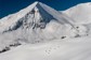 A group of skiers skiing downhill from a cat on a mountain in Colorado.